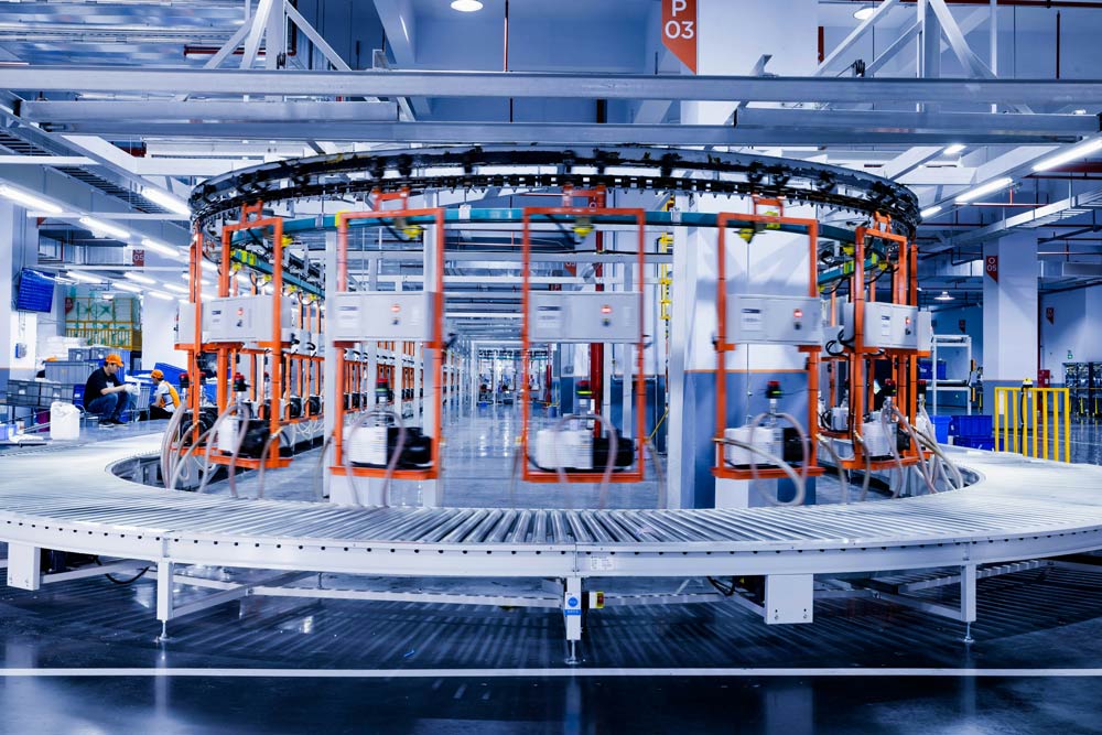 Automated production line in a factory setting with robotic arms and conveyor belts.